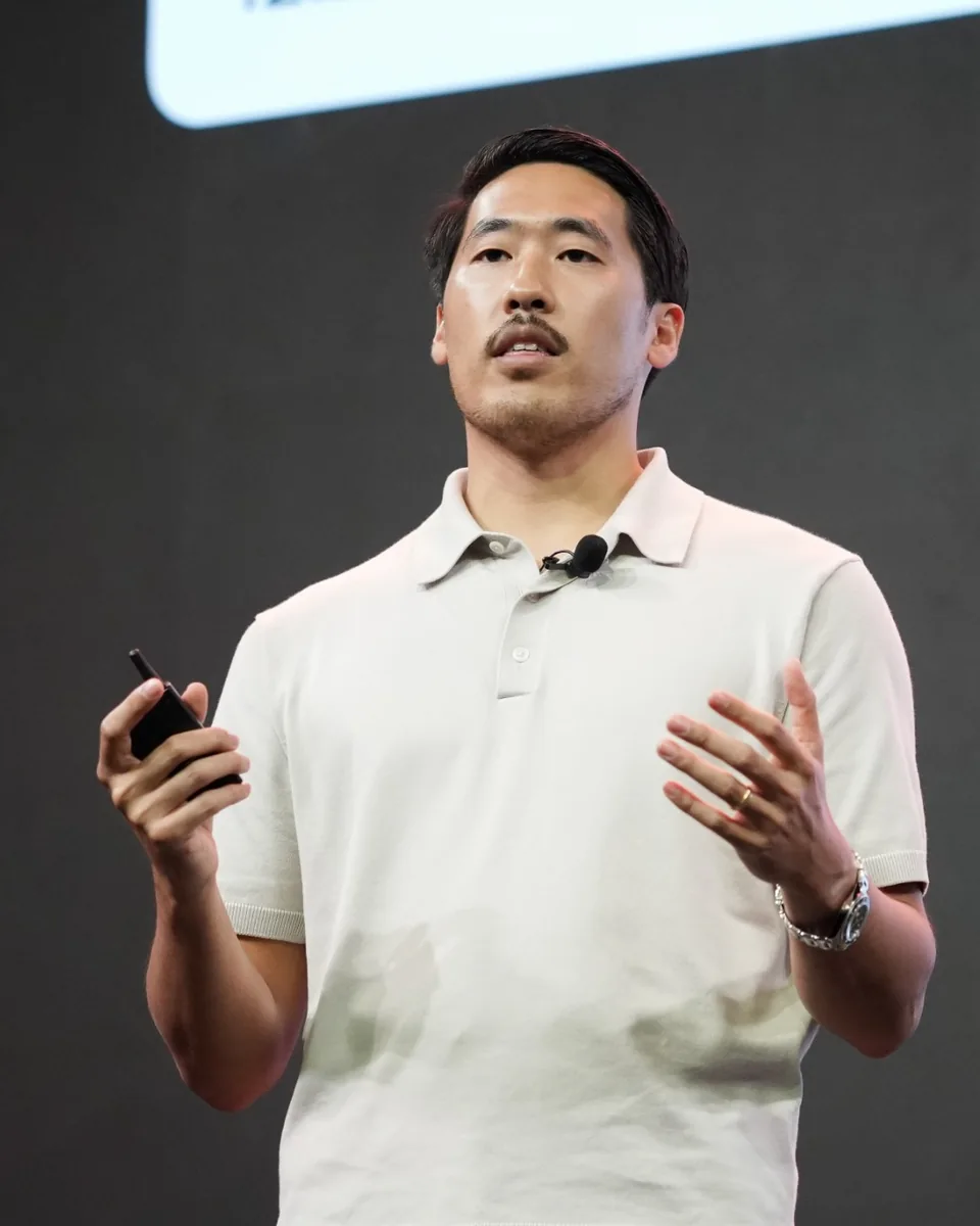 Derrick Choi presenting on stage at DevDay.